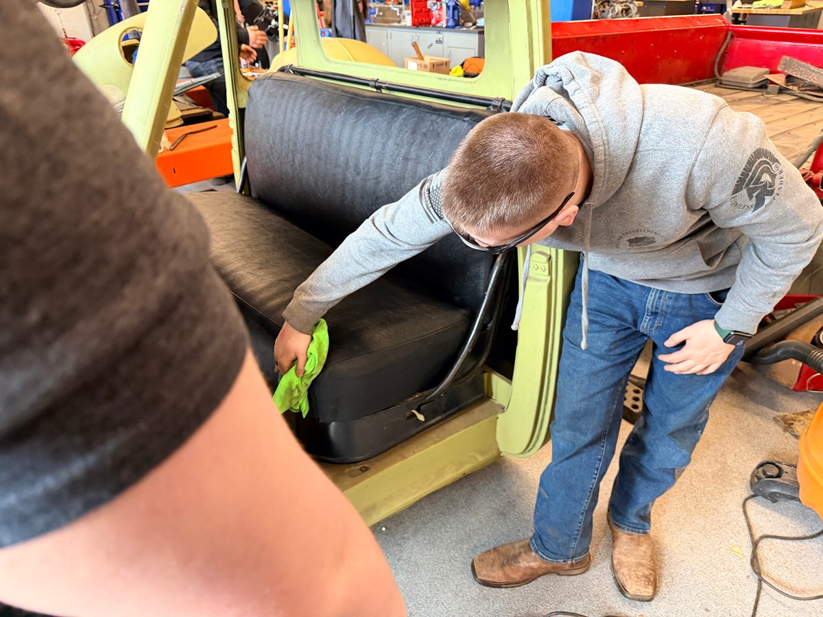 Student working inside the 1953 Chevrolet pickup cab